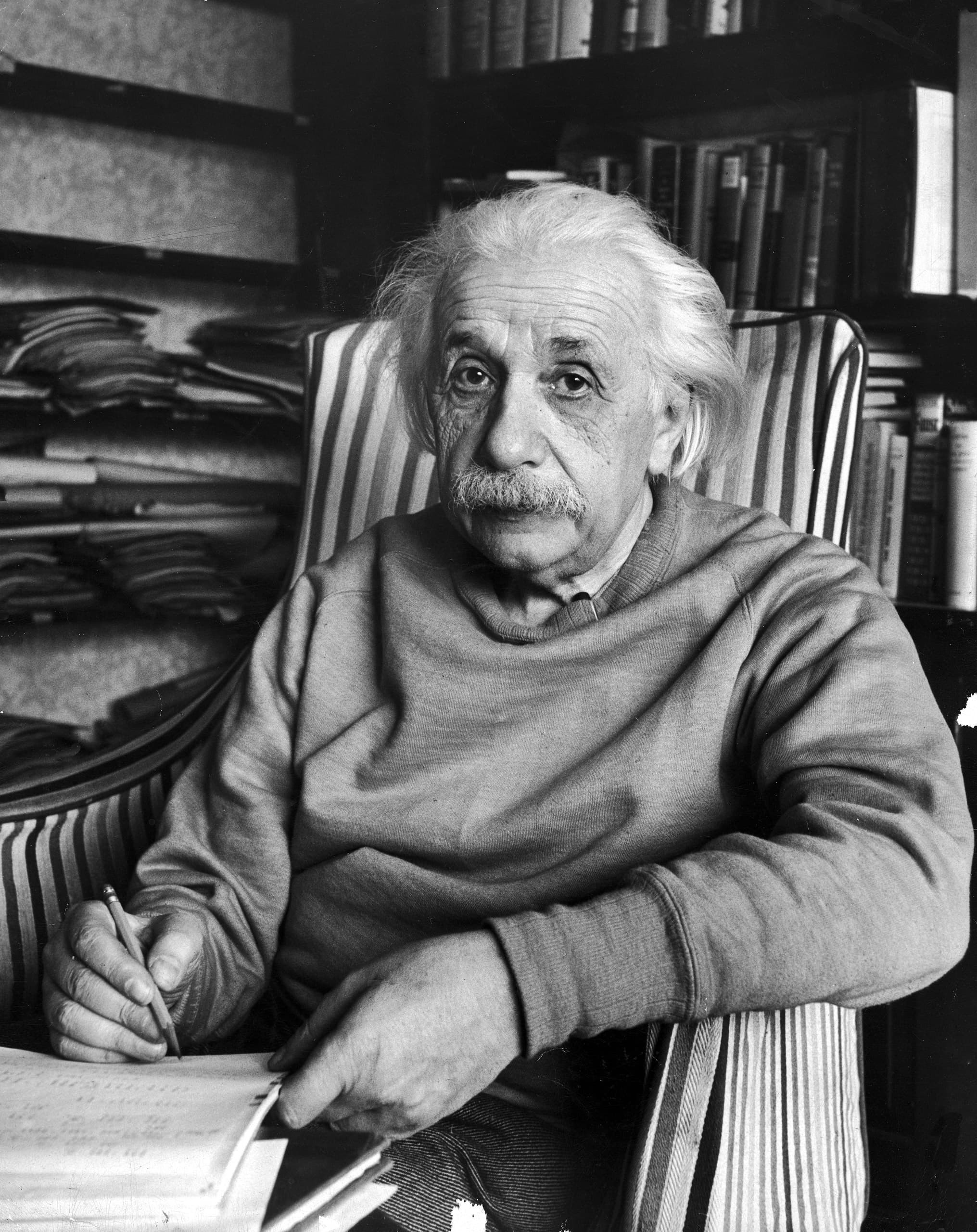 Albert Einstein writing at his desk